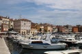 Boats in Rovinj harbor, Croatia with town behind