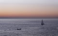 Boats sailing on the coast of the city of Donostia at sunset Royalty Free Stock Photo