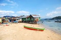 Boats at sand beach village coast with pier Royalty Free Stock Photo