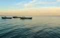 Boats in sea at sunrise Royalty Free Stock Photo