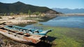 Boats by the shallow shore of Lugu Lake