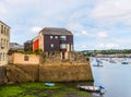 Boats and ships moored in a small port, in the background coastal town, fishing industry and tourism Royalty Free Stock Photo