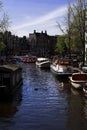 boats and ships sail on a river canal in the city of Amsterdam, Holland