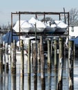 Boats shrink wrapped for the winter stored over water