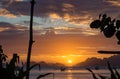 Boats silhouette in the sea on sunset and isles background with trees foreground. Fishing boat at sunset. Royalty Free Stock Photo