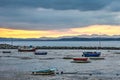 Boats and sloops on the beach at low tide