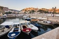 Boats at the small port in adriatic resort in old Ulcinj town during sunset