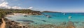 Boats in a small rocky cove with sandy beach in Corsica Royalty Free Stock Photo