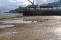 Boats stranded by low tide on the River Orwell at Pin Mill, Suffolk