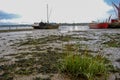 Boats stranded by low tide on the River Orwell at Pin Mill, Suffolk