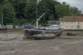 Boats stranded by low tide on the River Orwell at Pin Mill, Suffolk