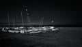 Boats stranded on the sand of a beach at night