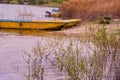 Boats tied up at shore of country lake Royalty Free Stock Photo