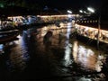 Boats touring the Amphawa Floating Market canal at dusk