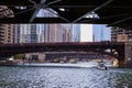 Boats with tourists on Chicago, IL canal with people on State Street bridge on sunny summer day Royalty Free Stock Photo