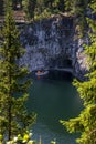 Boats with tourists float on the lake of the Great Marble Canyon in the Republic of Karelia in Russia