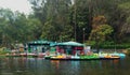 Boats are waiting for tour people at kodaikanal boat house at early morning with reflections. Royalty Free Stock Photo