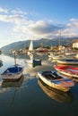 Boats on the water near seaside village on sunny autumn day. Montenegro, Bay of Kotor Royalty Free Stock Photo