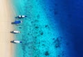 Boats on the water surface from top view. Turquoise water background from top view. Summer seascape from air. Gili Meno island, In Royalty Free Stock Photo