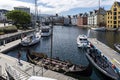 Boats on a wide water canal surrounded by colorful buildings in Alesund, Norway Royalty Free Stock Photo