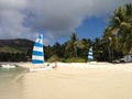 Boats, woman and palm trees on a tropical island beach