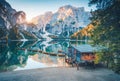 Boats and wooden house on the water on coast of Braies lake Royalty Free Stock Photo