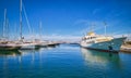 Boats and yachts anchored or moored in Athens marina and by its promenade in Glyfada on a bright summer day. Athens