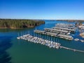 Boats and yachts docked and sailing in the marina on Lake Lanier with lush green trees and and a gorgeous clear blue sky Royalty Free Stock Photo