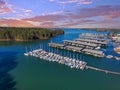Boats and yachts docked and sailing in the marina on Lake Lanier with lush green trees and and powerful clouds at sunset Royalty Free Stock Photo