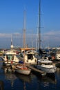 Boats and yachts at the pier in the evening marina