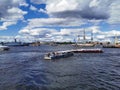 Boats and yachts with tourists sail to the Neva to see warships and sailboats for the Day of