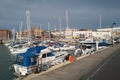 Boats and yatchs in Ramsgate Royal Habour. The impressive architecture of the buildings alonside the marina can be seen in the