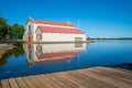 Boatshed building reflected in calm blue Lake Wendouree, Ballarat Australia