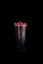 Boba smoothie tea with raspberry flavor isolated on a black background.