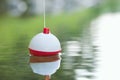 Bobber floating on water with ripples