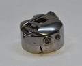 A bobbin case, sewing machine parts. Royalty Free Stock Photo