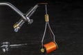 Bobbin of thread hanging from a hook on a fly tying vise Royalty Free Stock Photo