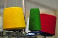 Bobbins with colored thread for industrial textile machines Royalty Free Stock Photo