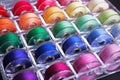 Bobbins with colorful threads in storage box
