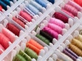 Bobbins with different colour embroidery threads in plastic sorting box Royalty Free Stock Photo