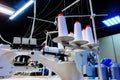 Bobbins with white threads secured in an industrial sewing machine Royalty Free Stock Photo