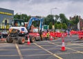 A Bobcat E57W Compact Excavator breaks up road surface during roadworks to improve the environment for pedestrians and cyclists