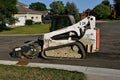 Bobcat excavator cleaning a street Royalty Free Stock Photo