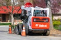 Bobcat S650 skid steer loader machine parked on the residential street during road maintenance project - San Jose, California, USA