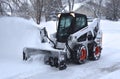 Bobcat Skid steer blows snow after a storm