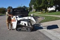 Bobcat Skid Steer dumping a bucket of rock