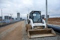 Bobcat skid-steer loader for loading and unloading works on city streets. ÃÂ¡ompact construction equipment Royalty Free Stock Photo