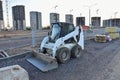 Bobcat skid-steer loader for loading and unloading works on city streets. ÃÂ¡ompact construction equipment for work in limited Royalty Free Stock Photo
