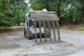 Bobcat tractor moving and unloading gravel on old road reconstruction Royalty Free Stock Photo