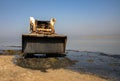 Bobcat, works to clean the beach, Skid loader Royalty Free Stock Photo